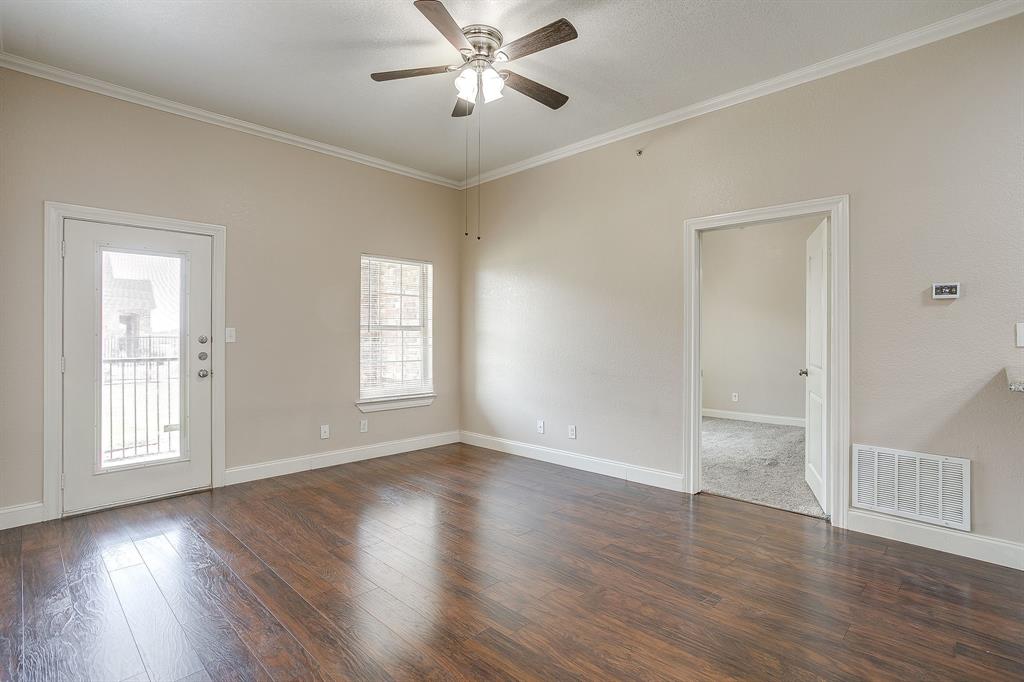 301 County Road 207, Unit 1206 Alvarado, TX 76009 - Photo 7 of 30 a view of an empty room with wooden floor and a window