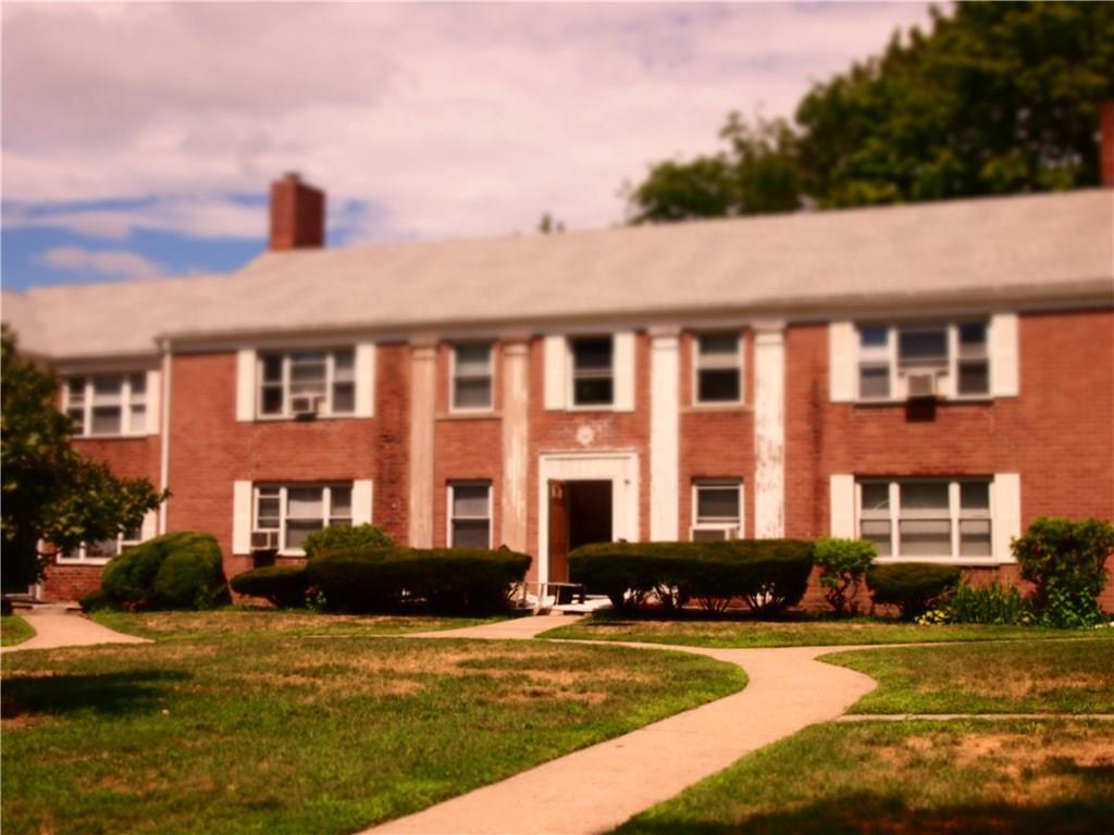 a front view of a building with a swimming pool