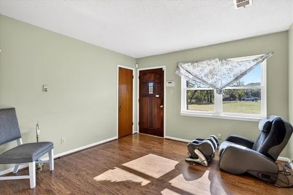 a kitchen with stainless steel appliances a stove a refrigerator cabinets and wooden floor