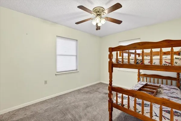 a view of walk in closet with clothes and window