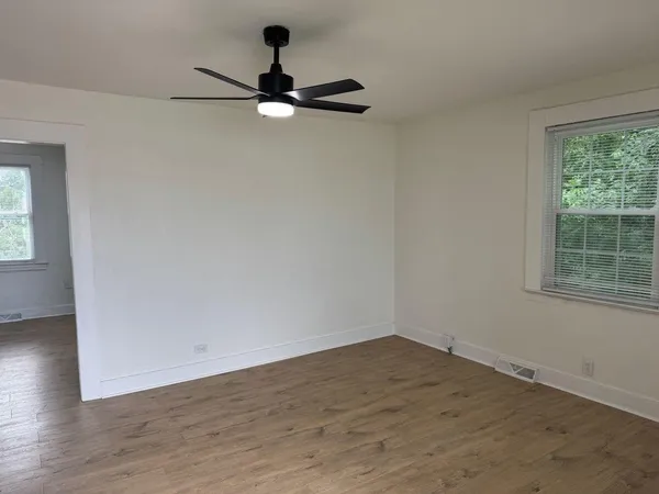 a view of a room with a window and a ceiling fan