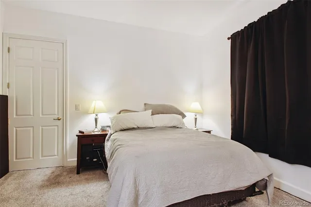 a bedroom with a bed and a lamp