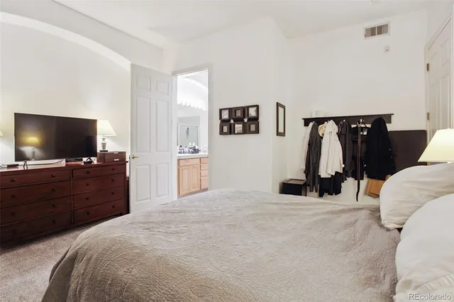 a room with a bed and a flat screen tv