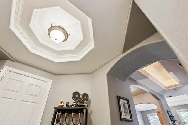 a view of a chandelier fan and wooden floor