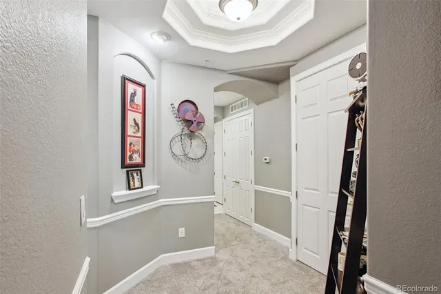 a view of a hallway with paintings on the wall