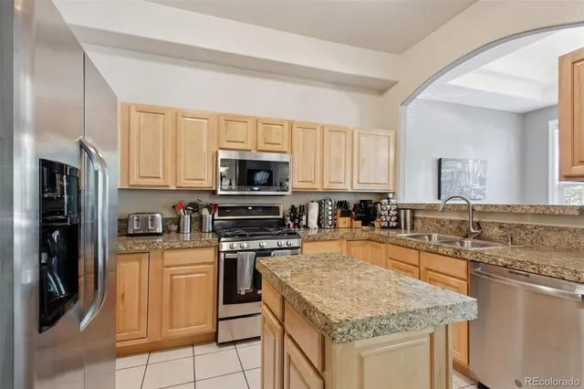 a kitchen with stainless steel appliances granite countertop a stove top oven a sink and dishwasher