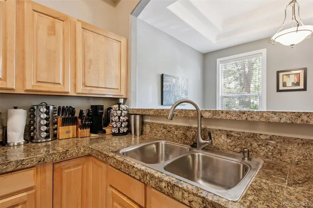 a kitchen with sink a refrigerator and cabinets