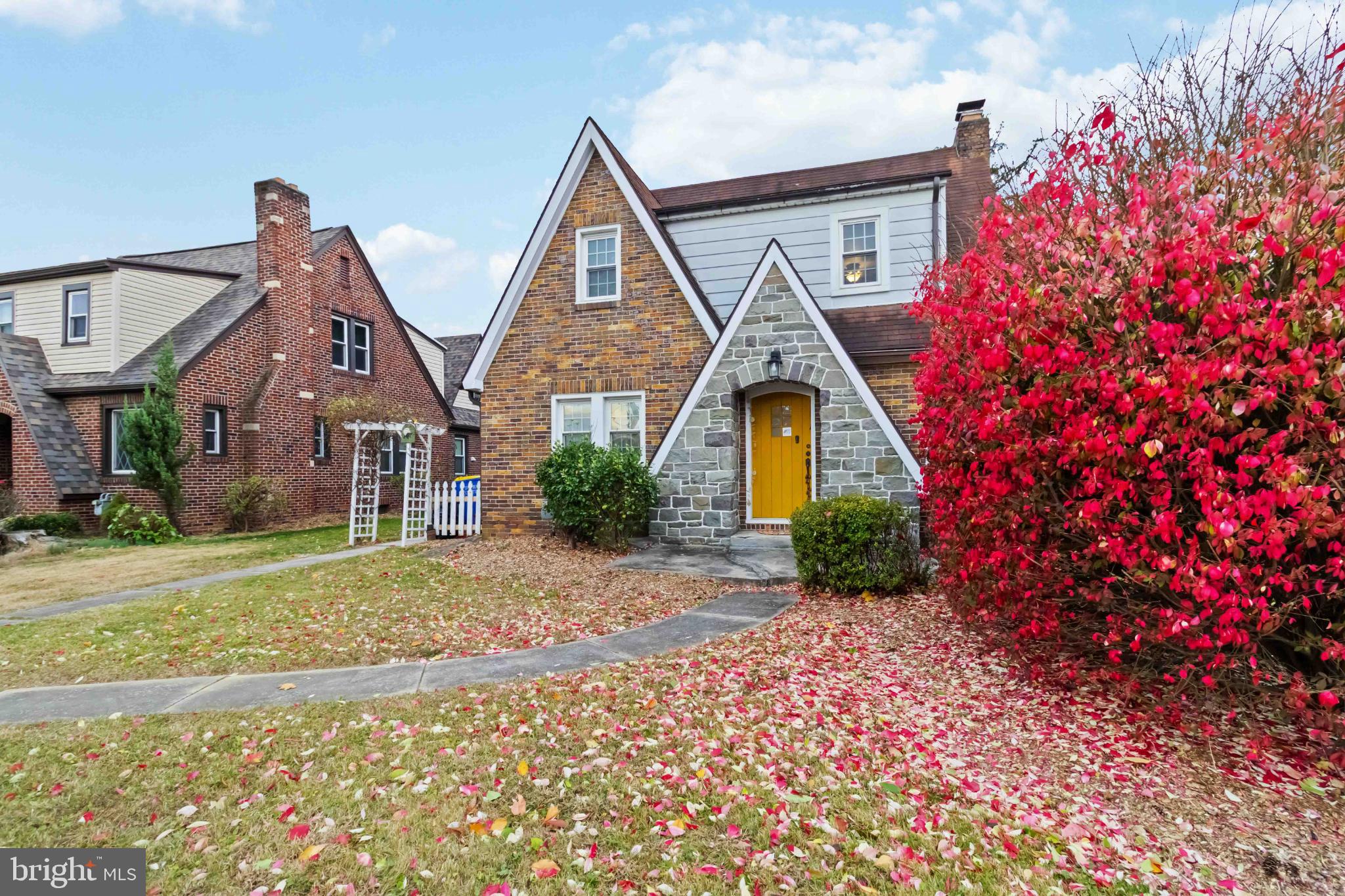 Charming home with vibrant autumn foliage.