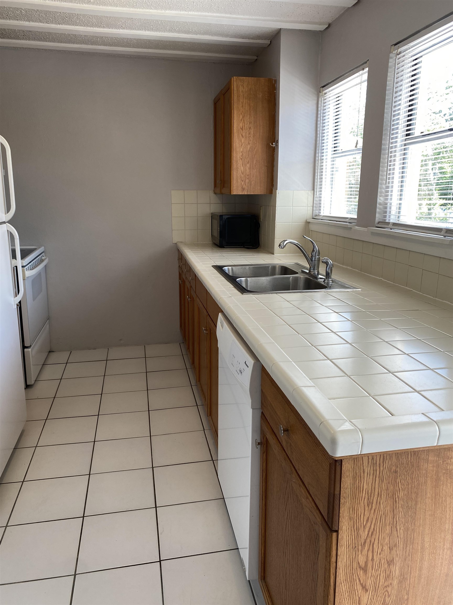147 Riberia Street, Unit D St. Augustine, FL 32084 - Photo 3 of 19 a kitchen with a sink a stove cabinets and a window