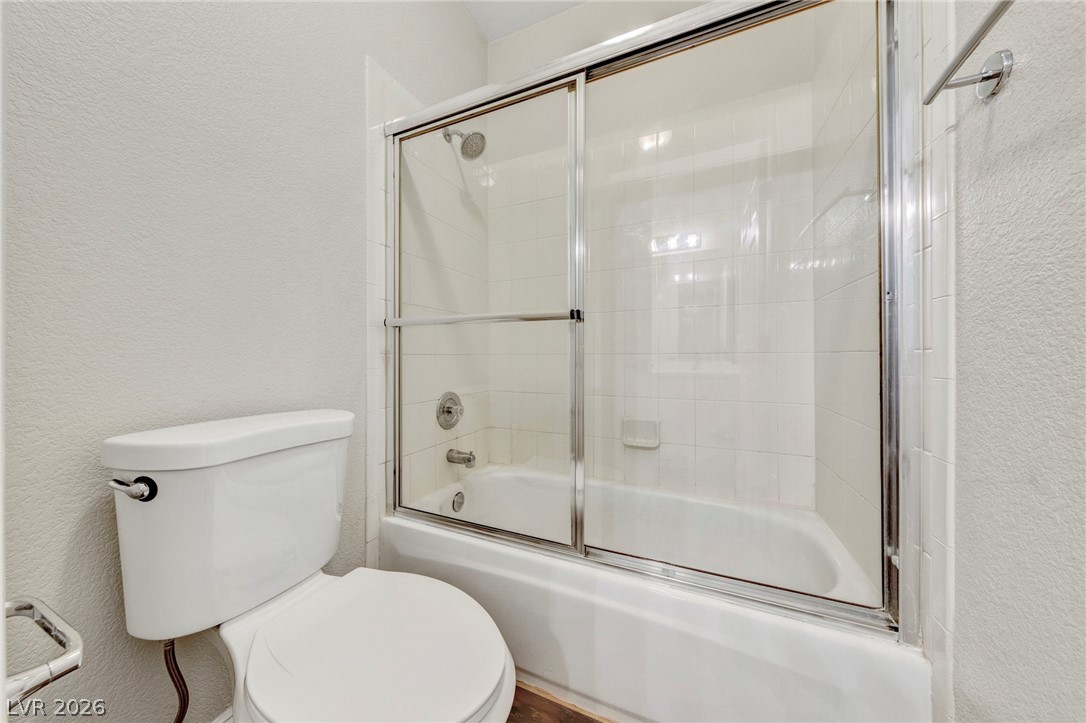 740 Aldo Rae Court, Unit NONE Henderson, NV 89052 - Photo 28 of 35 A well-maintained tub and shower with sliding glass doors defines this functional bathing area.