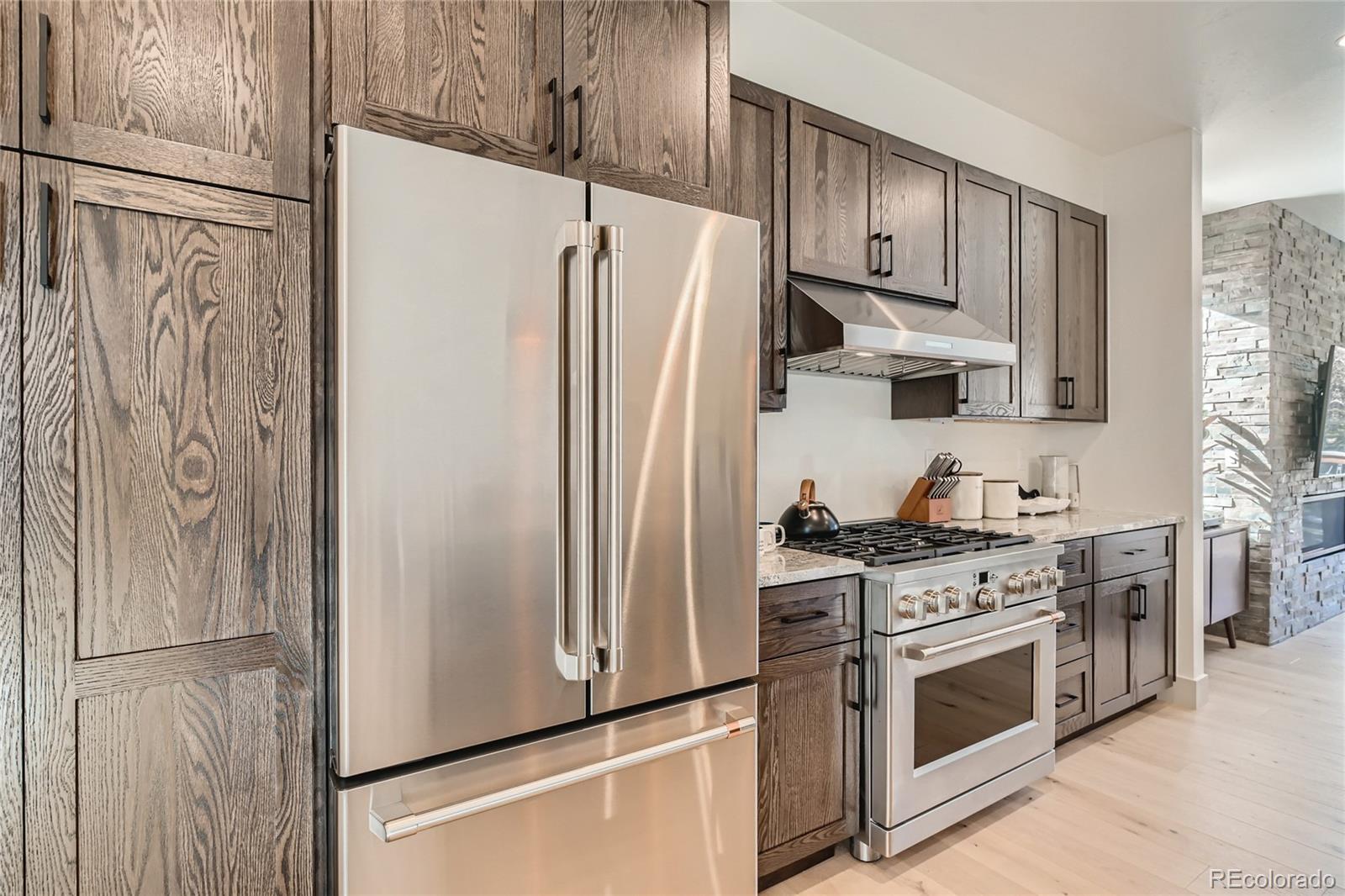 46 6th Street Silverthorne, CO 80498 - Photo 11 of 28 a kitchen with stainless steel appliances a refrigerator stove and cabinets
