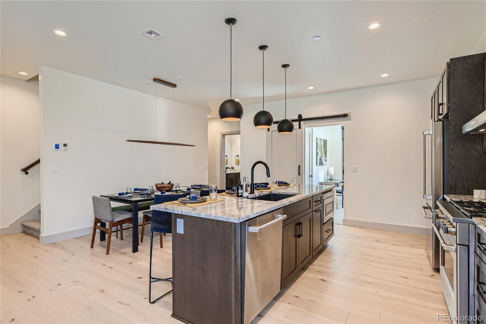 46 6th Street Silverthorne, CO 80498 - Photo 12 of 28 a kitchen with stainless steel appliances granite countertop a sink a stove and a refrigerator