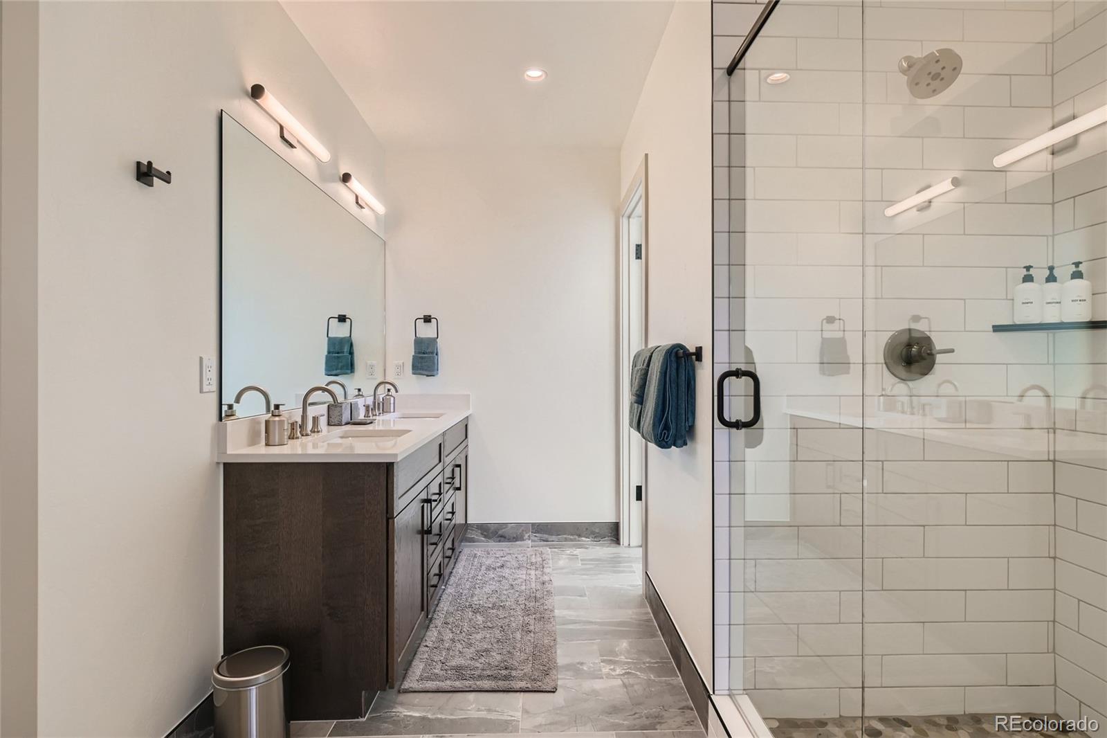 46 6th Street Silverthorne, CO 80498 - Photo 18 of 28 a bathroom with a double vanity sink a toilet and shower