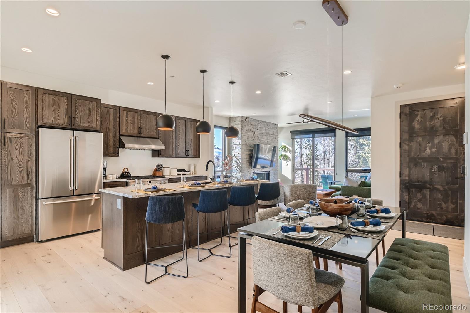 46 6th Street Silverthorne, CO 80498 - Photo 9 of 28 a kitchen with stainless steel appliances granite countertop a sink stove and refrigerator
