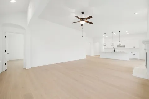 a view of empty room with a fan