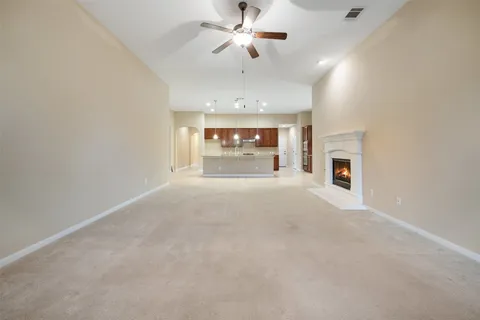 en view interior of a house with a ceiling fan and window