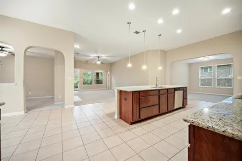 a view of a kitchen with kitchen island granite countertop a large counter top and floors