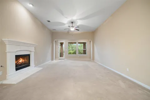an empty room with windows and a fireplace