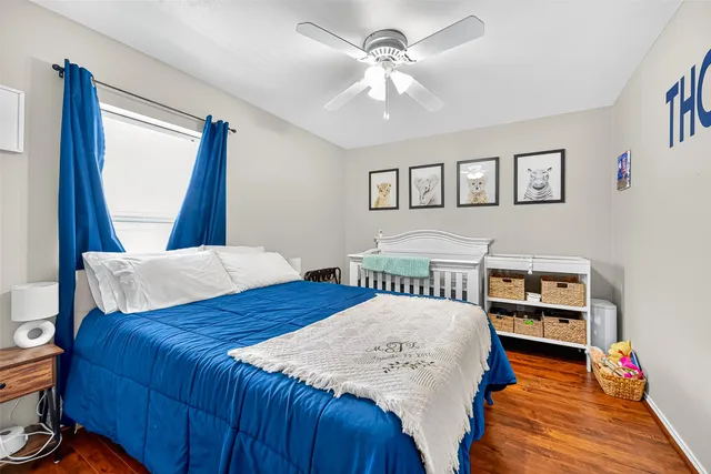 a bedroom with a bed and a large mirror on the dresser