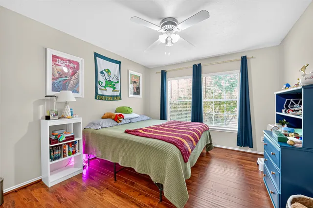 a bedroom with a bed cabinets and window