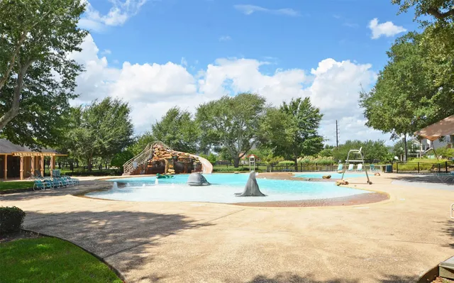 a view of a swimming pool with a lounge chair