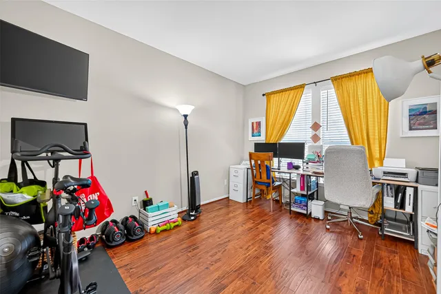 a view of a livingroom with workspace and a window