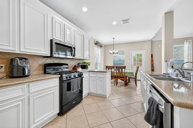 a kitchen with a sink cabinets and appliances