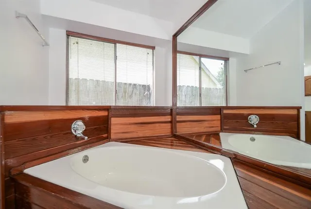 a bathroom with a double vanity sink and a mirror