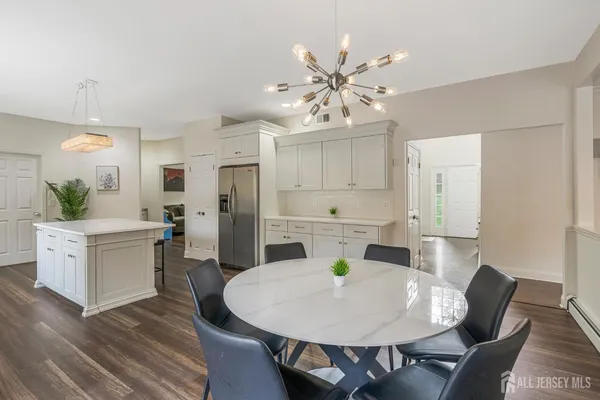 a view of a dining room with furniture and wooden floor