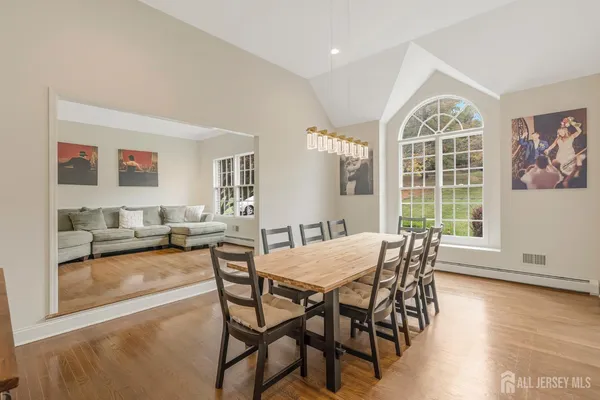 a view of a dining room with furniture window and wooden floor