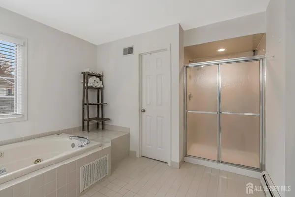 a bathroom with a tub and a shower