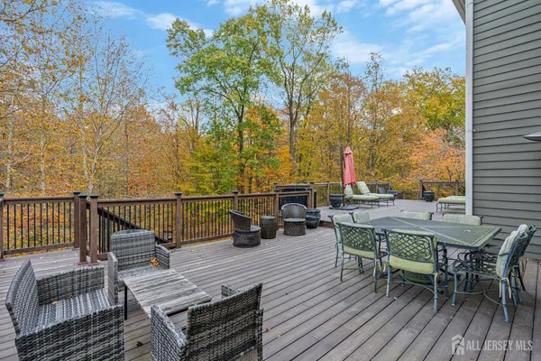 an outdoor sitting area with furniture and wooden floor