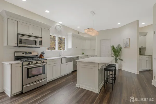 a kitchen with a stove a sink and a refrigerator