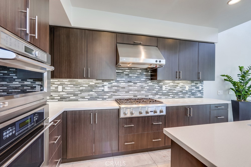 59 Gramercy Irvine, CA 92612 - Photo 17 of 71 a kitchen with stainless steel appliances wooden cabinets and a counter top space