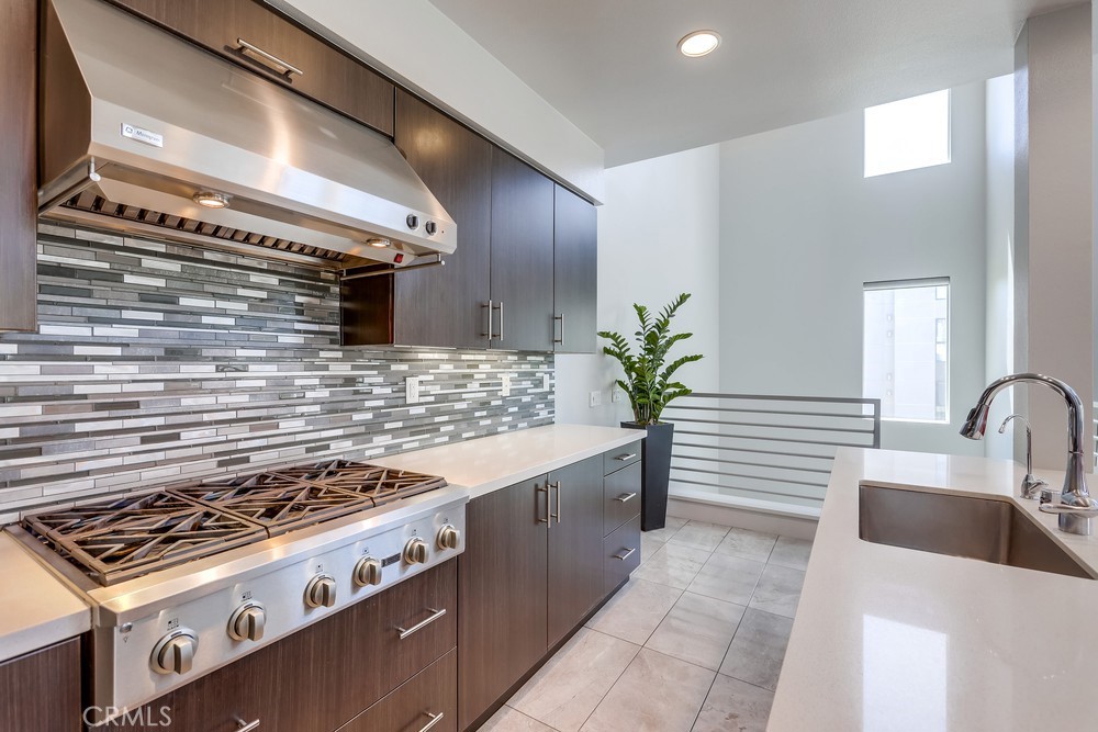 59 Gramercy Irvine, CA 92612 - Photo 18 of 71 a kitchen with granite countertop a stove and a sink