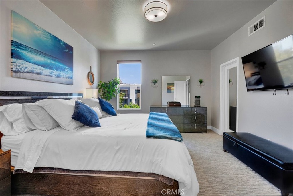 59 Gramercy Irvine, CA 92612 - Photo 28 of 71 a bedroom with a bed and flat screen tv