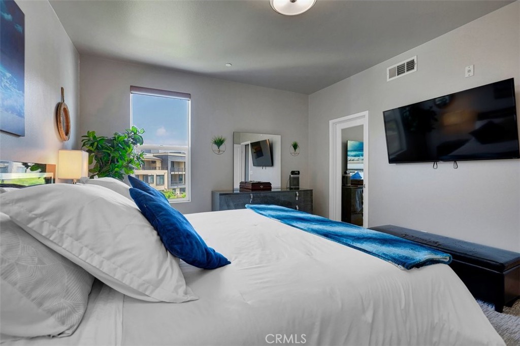 59 Gramercy Irvine, CA 92612 - Photo 29 of 71 a bedroom with a bed and a flat screen tv
