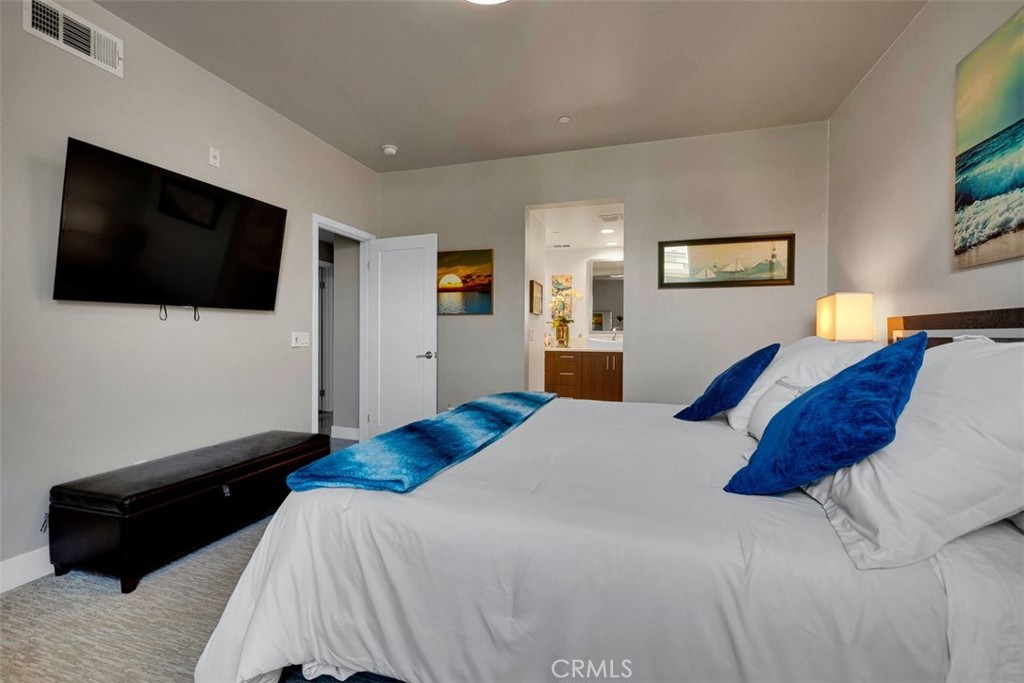 59 Gramercy Irvine, CA 92612 - Photo 30 of 71 a bedroom with a bed a flat screen tv and guitar