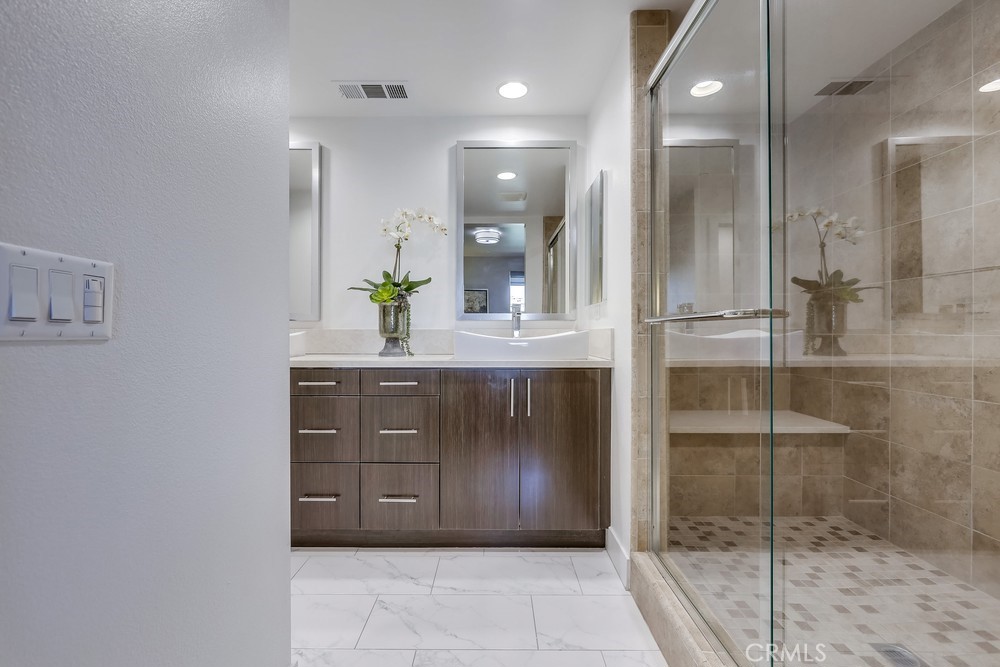 59 Gramercy Irvine, CA 92612 - Photo 31 of 71 a bathroom with a shower sink and mirror