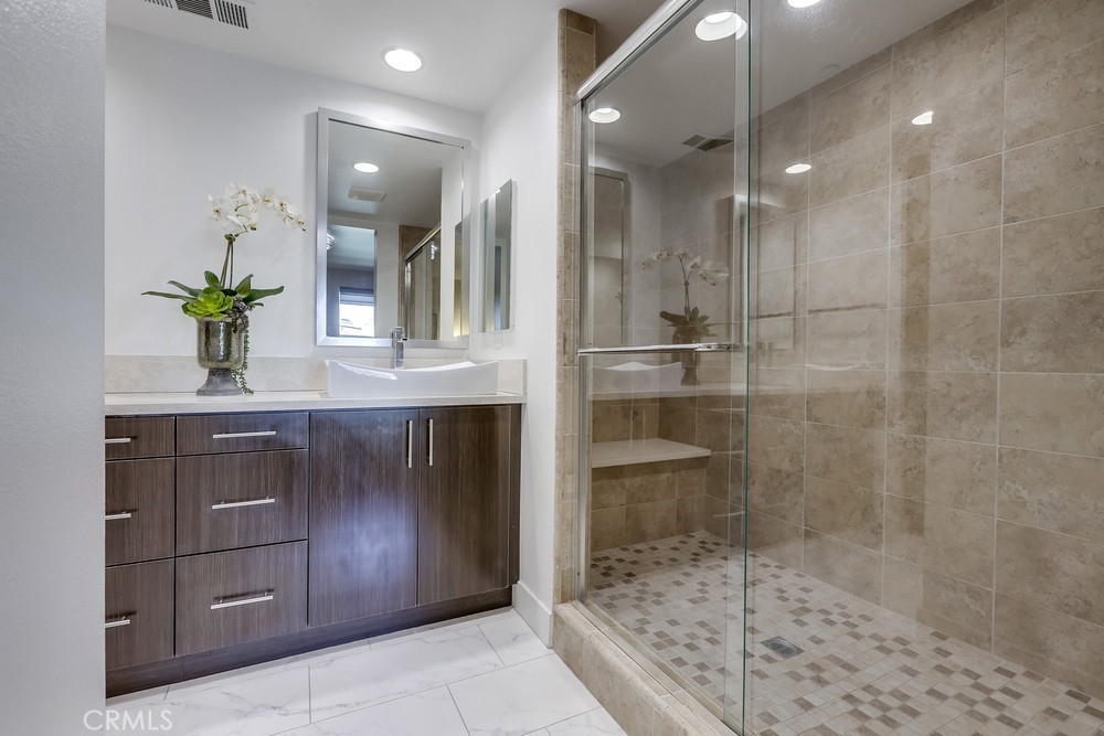59 Gramercy Irvine, CA 92612 - Photo 32 of 71 a bathroom with a shower sink and mirror