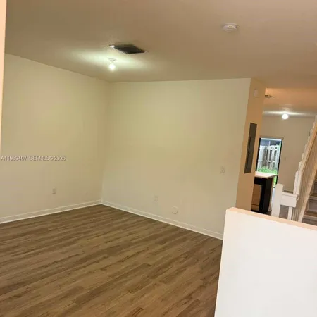 a view of hallway with wooden floor