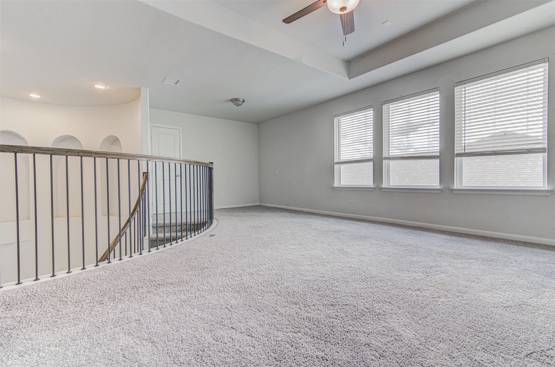 774 Cherrystone Loop Buda, TX 78610 - Photo 21 of 38 Well-lit and spacious, this room boasts soft carpeting and abundant natural light from multiple windows.
