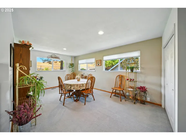 a living room with furniture a window and a flat screen tv