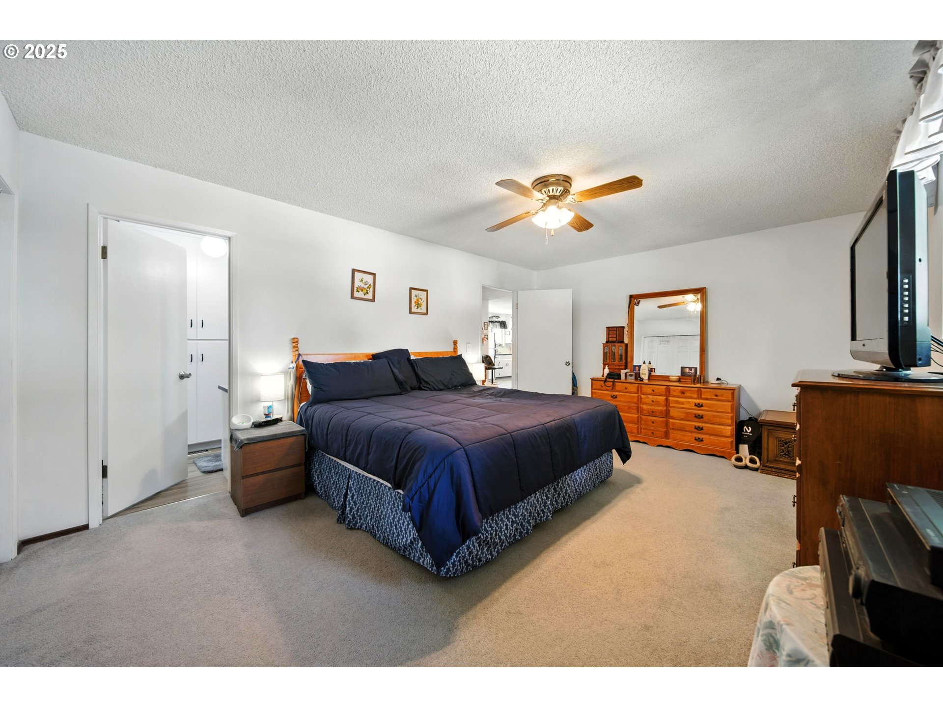 826 Southwest Jacquelyn Street Milton Freewater, OR 97862 - Photo 16 of 40 a spacious bedroom with a bed and a chandelier