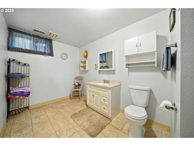 a bathroom with a sink toilet vanity and tub
