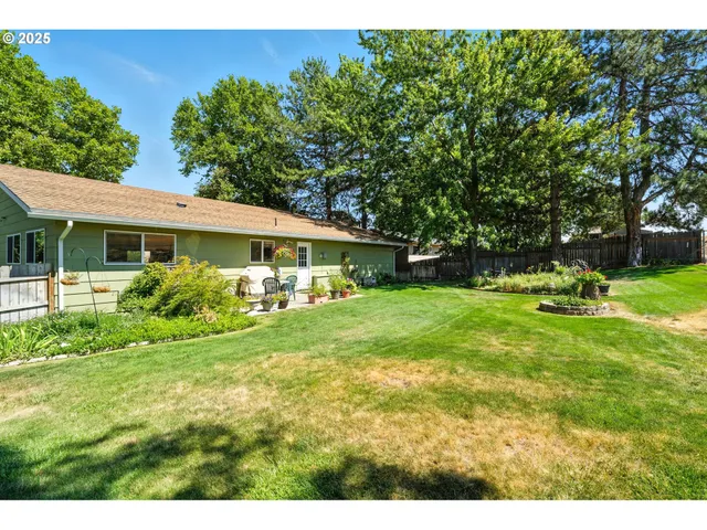 a view of house with backyard