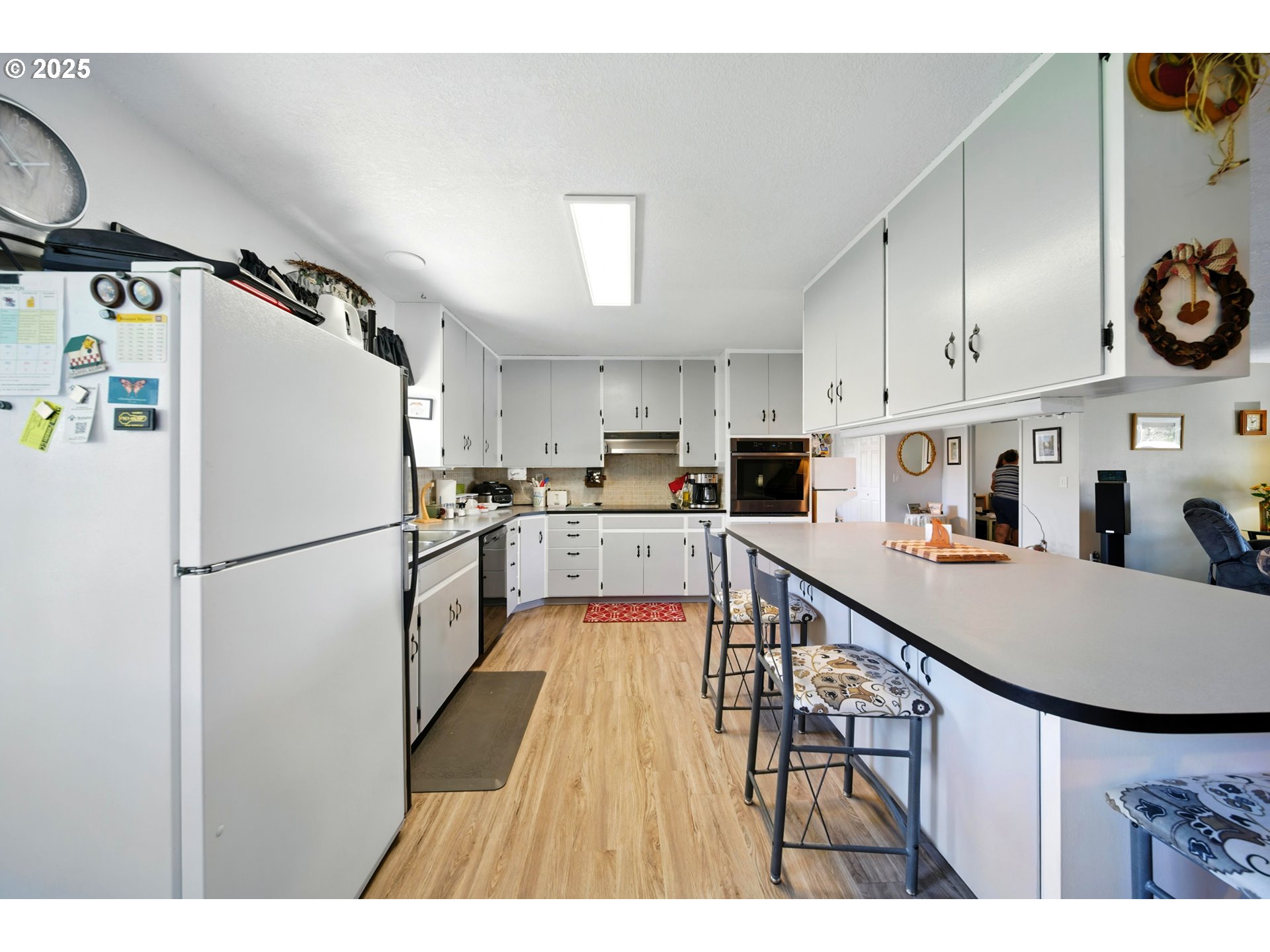 826 Southwest Jacquelyn Street Milton Freewater, OR 97862 - Photo 9 of 40 a kitchen with kitchen island a counter top space a refrigerator a stove a microwave and cabinets