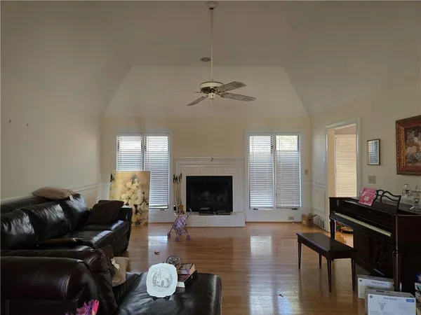 a living room with furniture fireplace and window