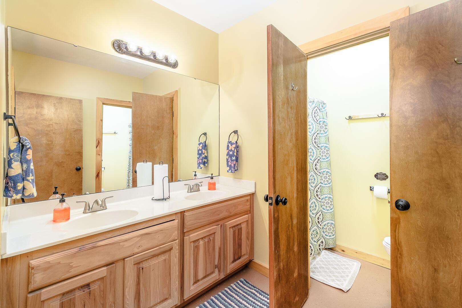 57 Hemlock Ridge Lane Catawba, VA 24070 - Photo 42 of 89 a bathroom with a double vanity sink a mirror and a shower