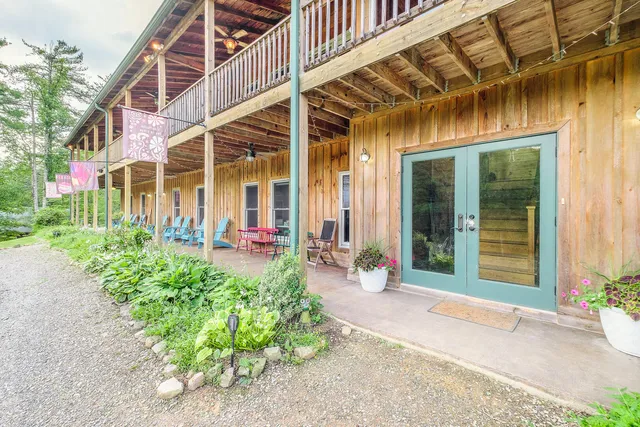 a view of a house with a big yard and potted plants